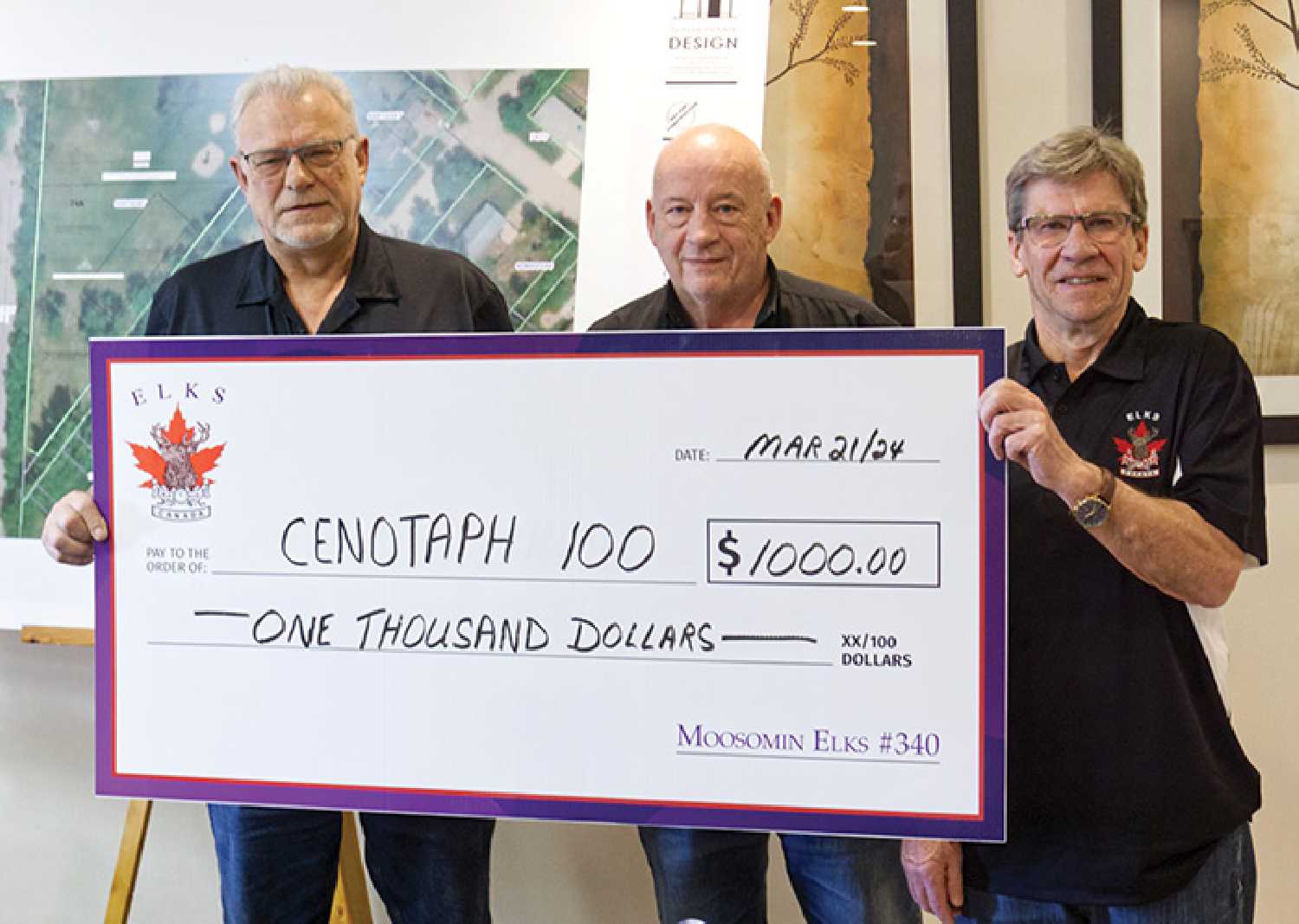 Ron Potter, left, and Mel Konkel, right, with the Moosomin Elks, present a $1,000 cheque to Brian Beckett, centre, of the Cenotaph 100 Committee to help with fundraising for the event. The presentation was made at the Chamber meeting last week.